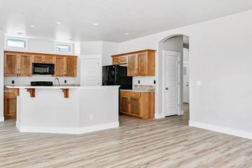Nampa apartment for rent - A kitchen with wooden cabinets and a white island.