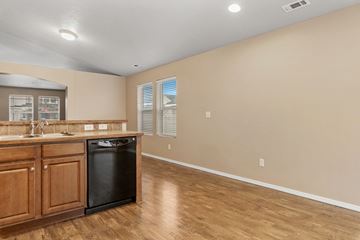 Kuna apartment for rent - A kitchen with wooden cabinets and a black dishwasher.