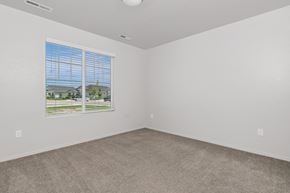 Nampa apartment for rent - A room with a window showing a view of houses and trees.