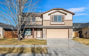 Meridian apartment for rent - the front of a house with a garage door and a tree