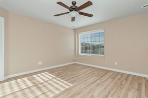 Meridian apartment for rent - an empty living room with a ceiling fan and a window
