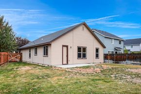 Meridian apartment for rent - the back of a house with a yard and a fence