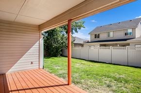 Boise apartment for rent - A wooden deck leads to a house with a white fence.