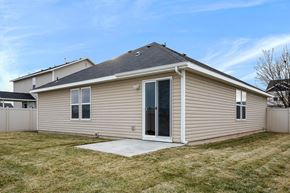 Kuna apartment for rent - A house with a grey roof and beige siding with a white door and windows.
