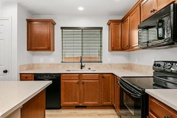 Meridian apartment for rent - A kitchen with wooden cabinets and black appliances.