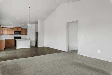Nampa apartment for rent - A kitchen with wooden cabinets and a white island.
