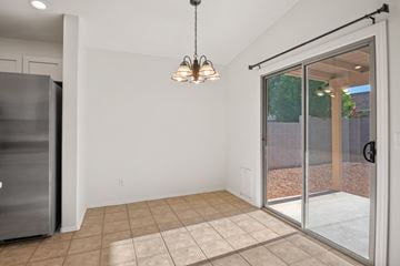 Tucson apartment for rent - A kitchen with a refrigerator and a chandelier.