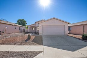 Tucson apartment for rent - an empty driveway in front of a house with the sun shining