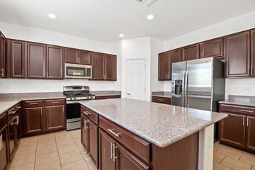 Tucson apartment for rent - A kitchen with brown cabinets and a granite countertop.