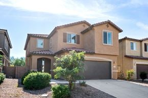 Tucson apartment for rent - a house with a garage and a driveway in front of it