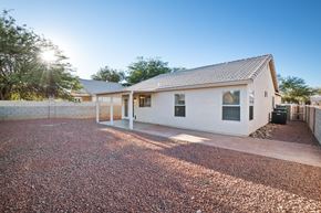 Tucson apartment for rent - A house with a gravel driveway in front.