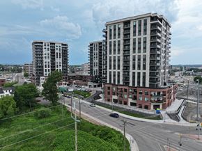 Moncton apartment for rent - A view of a city street with a large building in the background.