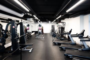Moncton apartment for rent - A gym with treadmills, weights, and exercise equipment.