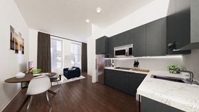 Baltimore apartment for rent - a kitchen with black cabinets and a table and chairs