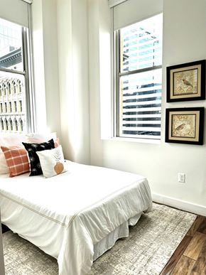 Baltimore apartment for rent - a bedroom with a white bed and two windows