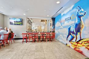 Baltimore apartment for rent - a dining room with red chairs and a mural of a blue horse