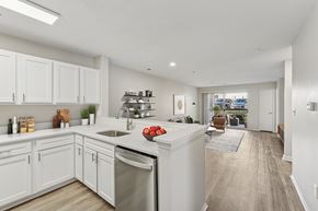 Chapel Hill apartment for rent - A kitchen with white cabinets and a wooden floor.