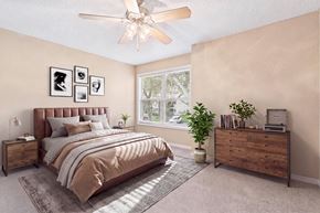 Tampa apartment for rent - A bedroom with a bed, nightstand, and a window with a view of trees.