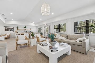 Tampa apartment for rent - A well-lit, spacious living room with a white coffee table and beige sofa.