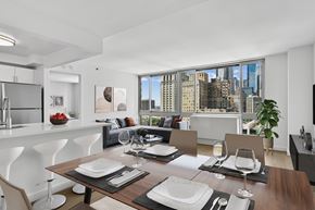New York apartment for rent - A modern dining room with a view of the city.