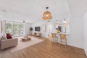 Coral Springs apartment for rent - A living room with a couch, chairs, and a television.
