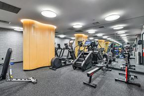 New York apartment for rent - A gym with a variety of equipment including treadmills, weights, and exercise machines.