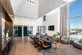 Jersey City apartment for rent - a dining room with a long wooden table and a large window