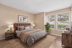 Tampa apartment for rent - A bedroom with a large bed and a window with blinds.