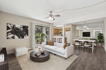 Tampa apartment for rent - A living room with a white couch and a coffee table.