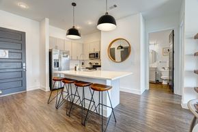 Nashville apartment for rent - a kitchen with a white counter top and bar stools