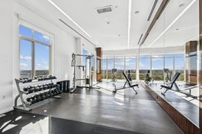Mclean apartment for rent - A gym with a view of the sky through the windows.