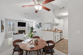 Raleigh apartment for rent - A dining room with a table set for two and a fireplace in the background.