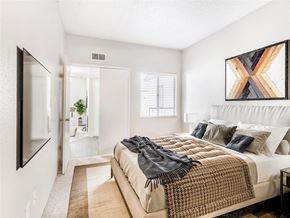 Mesa apartment for rent - A bedroom with a bed covered in a blanket and pillows.