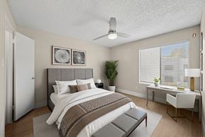 Chandler apartment for rent - A bedroom with a large bed and a desk with a chair.