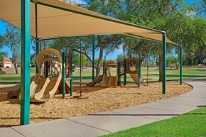 Chandler apartment for rent - A playground with a yellow slide and a green canopy.
