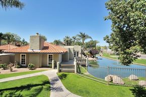 Chandler apartment for rent - A house with a red tile roof and a pool in the backyard.