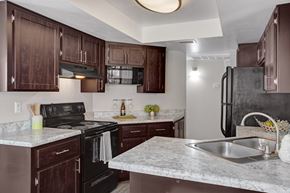 Chandler apartment for rent - A kitchen with brown cabinets and a marble countertop.