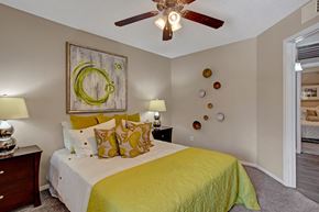Chandler apartment for rent - A bedroom with a bed, two lamps, and a ceiling fan.