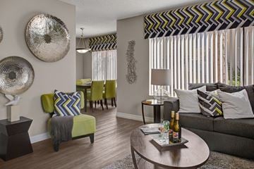 Chandler apartment for rent - A living room with a green couch and a table with a bottle of wine on it.