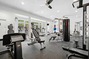 Charlotte apartment for rent - A gym with a variety of equipment including treadmills, weights, and a bench press.