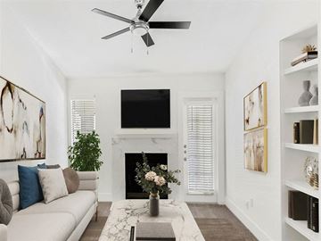 Austin apartment for rent - A living room with a fireplace, a couch, a coffee table, and a painting on the wall.