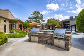 Charlotte apartment for rent - A stone BBQ grill is in the middle of a driveway.