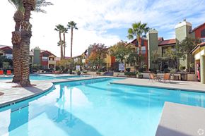 Las Vegas apartment for rent - One of 4 swimming pools with palm trees and sun deck.