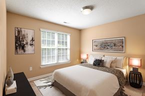 Charlotte apartment for rent - a bedroom with a large bed and a window