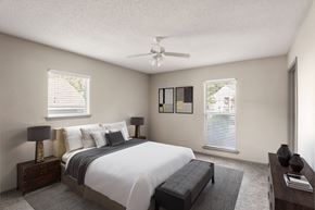 Chapel Hill apartment for rent - a bedroom with a large bed and a ceiling fan