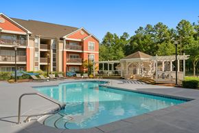 Chapel Hill apartment for rent - A swimming pool in front of a building with a gazebo in the background.