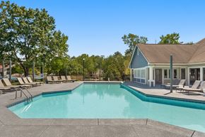 Chapel Hill apartment for rent - a swimming pool with chairs and a house in the background