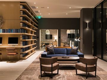 Los Angeles apartment for rent - A living room with a blue couch and a bookshelf.