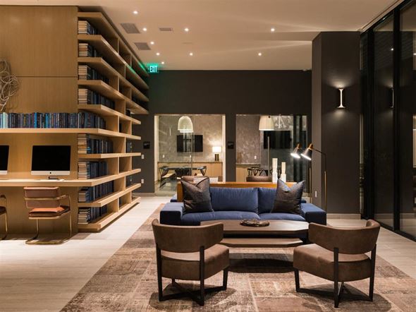 Los Angeles apartment for rent - A living room with a blue couch and a bookshelf.