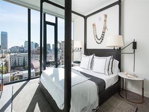 Los Angeles apartment for rent - a bedroom with a bed and a view of the city